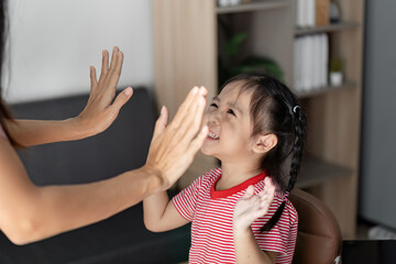 Joyful Child Engaging in Interactive Learning Activity with Teacher in a Modern Classroom Setting