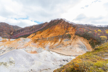 The landscape of a volcano, Jigokudani or Hell Valley is a spectacular valley and a main hot spring waters source of Noboribetsu Onsen Town: Noboribetsu, Hokkaido, Japan, autumn leaves.