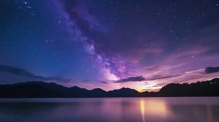 Fototapeta premium A stunning time-lapse capturing the transition from starry night to golden dawn in Phangnga, Thailand, The Milky Way wheels majestically overhead, its celestial river gradually fading as sunlight