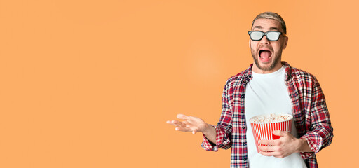 Horror film concept. Scared guy in 3d glasses tossed popcorn