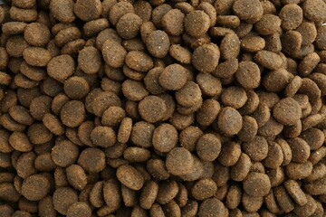 Pet food granules as background, top view