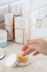 Mockup of an open jar of body cream. Cosmetology products. With a woman's hand. Blank label. Place for inscription and logo. top view.