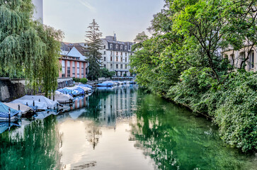 Fototapeta premium Zurich, Switzerland - July 26, 2024: Boats along the waterway of the Schanzengraben Promenade Zurich Switzerland 