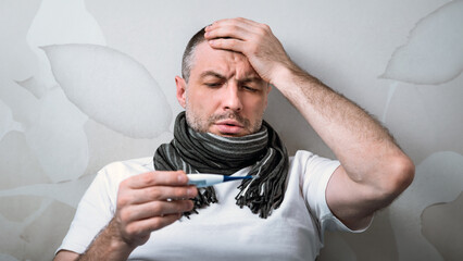 Sick Man Having Fever Measuring Temperature With Thermometer Having Flu Symptoms Lying In Bed At Home. Selective Focus