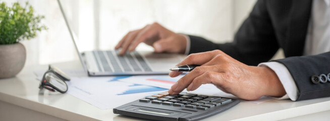 Banner Asian Business man hands using calculator counting tax financial bill. Tax audit Finacial...