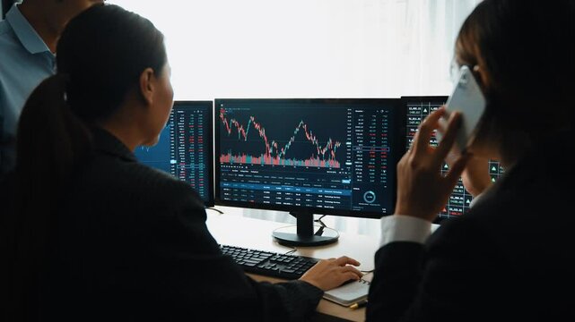 Slow motion business investors in stock trading company analyzing stock exchange marketing looking at monitors analyzing candle bar price for loss and grow up gain and profits. Burgeoning