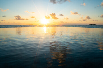 Naklejka premium Sunset views from overwater pool villa in Maldives