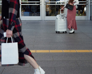 冬の名古屋の駅前の繁華街を渡る人々の姿