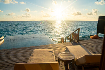 Sunset views from overwater pool villa in Maldives
