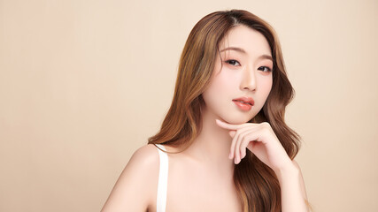 Beautiful young asian woman with clean fresh skin on beige background, Face care, Facial treatment, Cosmetology, beauty and spa, Asian women portrait.