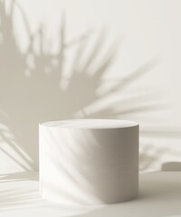 Modern round podium table on cream white counter in dappled sunlight, leaf foliage shadow on wall...