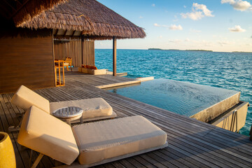 Sunset views from overwater pool villa in Maldives