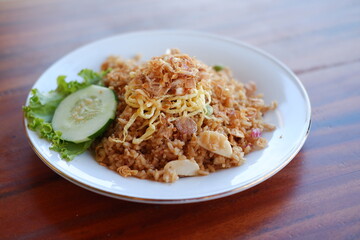 seafood fried rice with egg on wooden table