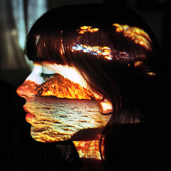 Ocean cliffs projected onto her face