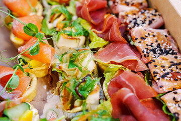 A box with an assortment of meat and fish appetizers for the buffet table. 