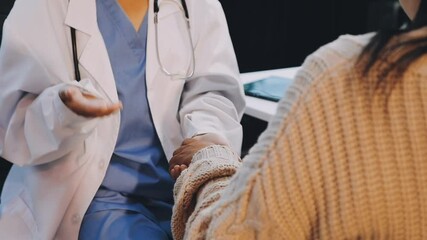 The doctor hold hands patient Which sat on wheelchair to encourage To fight the disease And cheer to receive treatment, to health care concept.