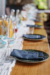 a served banquet table with gray plates and napkins