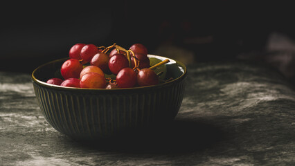 Close-Up of Fresh Green and Red Grapes in a Dark Bowl