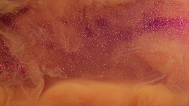 Glitter texture. Fire design. Defocused orange flows smoking clouds bright volumes on gleaming purple modern art abstract background.