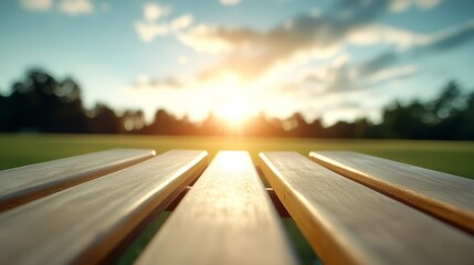 Fototapeta premium A wooden bench sitting on top of a lush green field