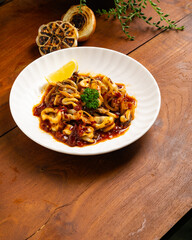 sweet and sour squid sauce, calamari served with Indonesian sauce with garnish