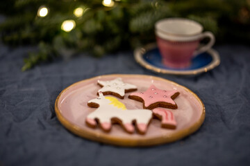 Close-up of decorated winter cookies featuring sleeping polar bears and stars with silver pearl details and royal icing on dark background.
