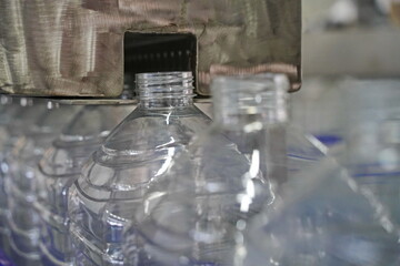 Plastic bottles on a conveyor belt at the factory.