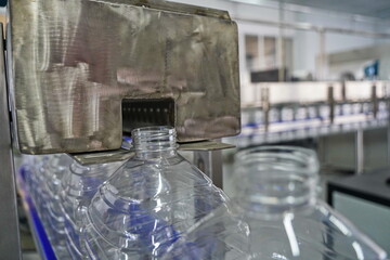 Plastic bottles on a conveyor belt at the factory.