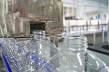 Plastic bottles on a conveyor belt at the factory.