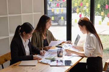 Asian businesswoman teamwork working on laptop with finances analysis report at desk in office, business financing, accounting banking, Team of creative and business planning, 