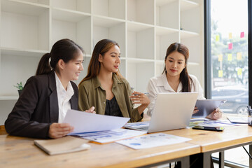 Asian businesswoman teamwork working on laptop with finances analysis report at desk in office, business financing, accounting banking, Team of creative and business planning, 