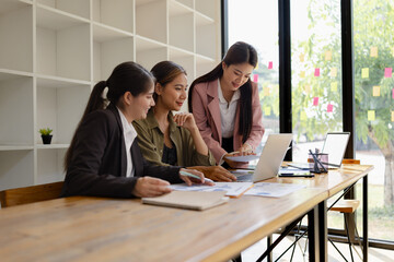 Asian businesswoman teamwork working on laptop with finances analysis report at desk in office, business financing, accounting banking, Team of creative and business planning, 