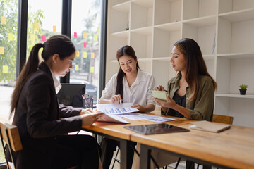 Asian businesswoman teamwork working on laptop with finances analysis report at desk in office, business financing, accounting banking, Team of creative and business planning, 