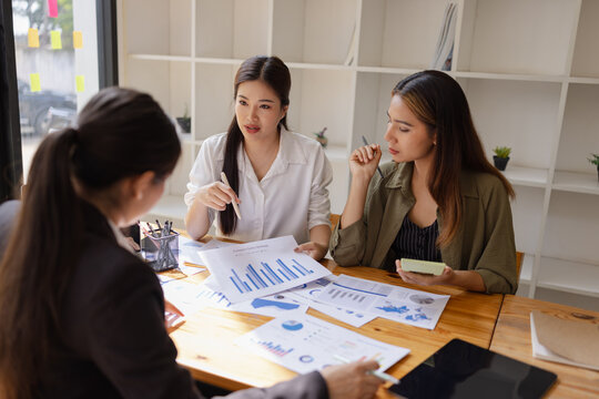 Asian businesswoman teamwork working on laptop with finances analysis report at desk in office, business financing, accounting banking, Team of creative and business planning,  - Powered by Adobe