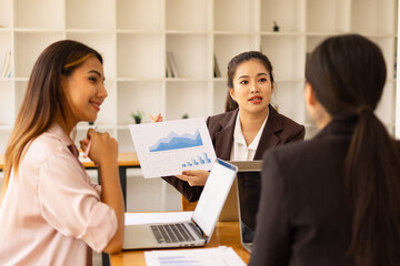 Obraz premium Asian businesswoman teamwork working on laptop with finances analysis report at desk in office, business financing, accounting banking, Team of creative and business planning, 