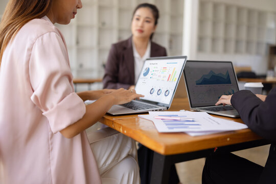 Technology and financial advisory services concept. Businesswoman teamwork and working on digital laptop computer with advisor showing plan of investment to clients at table office. Digital marketing.