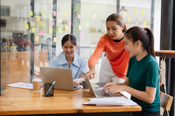 Excited Asian businesswoman team working together in office, About successful startup projects concept.