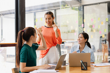 Fototapeta premium Excited Asian businesswoman team working together in office, About successful startup projects concept.