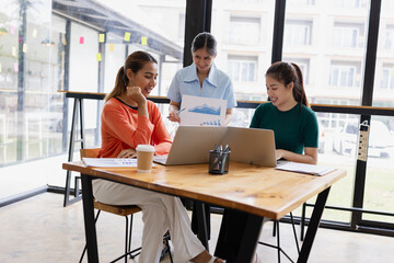 Technology and financial advisory services concept. Businesswoman teamwork and working on digital laptop computer with advisor showing plan of investment to clients at table office. Digital marketing.