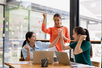Fototapeta premium Excited Asian businesswoman team working together in office, About successful startup projects concept.