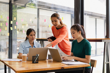 Technology and financial advisory services concept. Businesswoman teamwork and working on digital laptop computer with advisor showing plan of investment to clients at table office. Digital marketing.