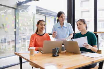 Technology and financial advisory services concept. Businesswoman teamwork and working on digital laptop computer with advisor showing plan of investment to clients at table office. Digital marketing.