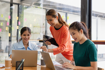 Technology and financial advisory services concept. Businesswoman teamwork and working on digital laptop computer with advisor showing plan of investment to clients at table office. Digital marketing.