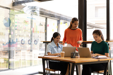 group of asian businesswoman working on laptop with finances analysis report at desk in office, business financing, accounting banking, Team of creative and business planning, 