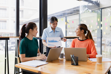 group of asian businesswoman working on laptop with finances analysis report at desk in office, business financing, accounting banking, Team of creative and business planning, 