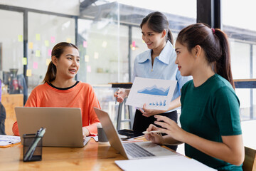 group of asian businesswoman working on laptop with finances analysis report at desk in office, business financing, accounting banking, Team of creative and business planning, 