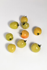 Little green tomatoes on isolated white background