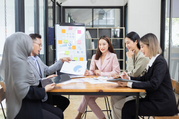 Team of Asian business people and working together in office, Startup projects and business presentation at meeting room.