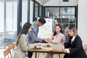 Team of Asian business people and working together in office, Startup projects and business presentation at meeting room.