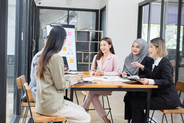 Team of Asian business people and working together in office, Startup projects and business presentation at meeting room.